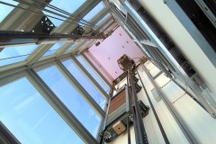 a modern elevator shaft with glass windows